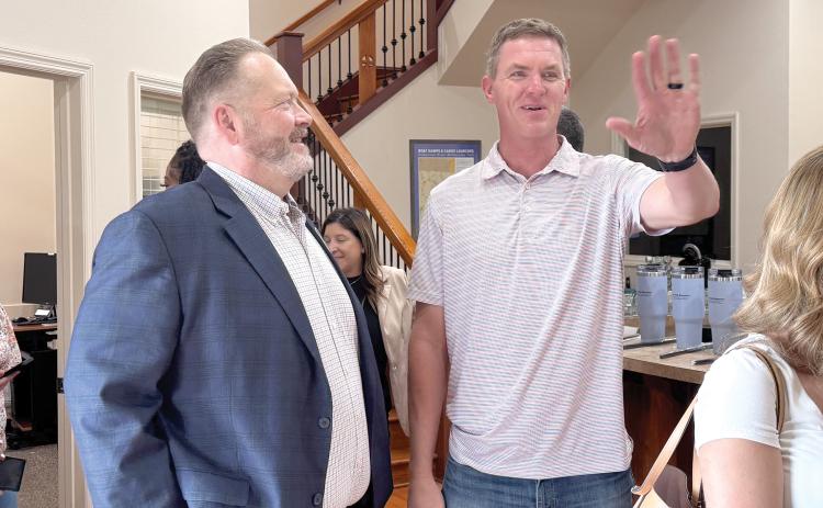 Todd Wilson (left), the publisher of the Lake City Reporter and Live Oak Reporter, speaks with Suwannee County Parks and Recreation Director Alden Rosner during the Reporter’s mix and mingle at its Live Oak office last month. (JAMIE WACHTER/Lake City Reporter)