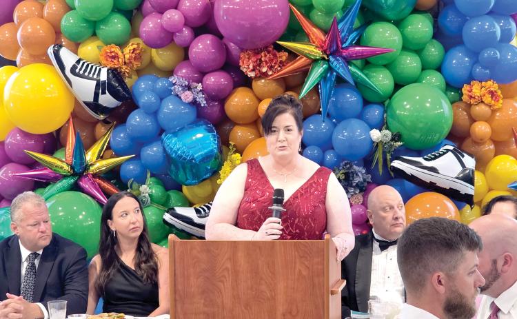 Catholic Charities Regional Director Shannon Moser speaks during Saturday’s Laced Up for Love Sneaker Ball at the Nutrien Conference Center in White Springs. (TONY BRITT/Lake City Reporter)