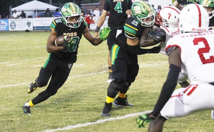 Suwannee running back Lou Jack Smith eyes a hole behind a block from guard Brody Bean against Hamilton County last Friday. (JAMIE WACHTER/Lake City Reporter)