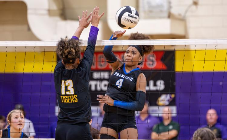 Branford hitter Adriauna Combs (4) and Union County hitter Jailyn Simmons (13) battle at the net during the District 6-R championship on Thursday. (JACK HOWDESHELL/Lake City Reporter)