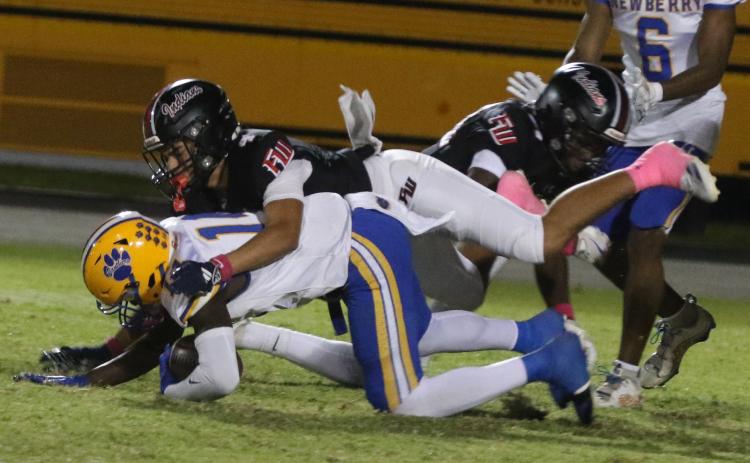 Fort White defensive back Ja’vion Bailem makes a tackle against Newberry on Oct. 17. (MORGAN MCMULLEN/Lake City Reporter)