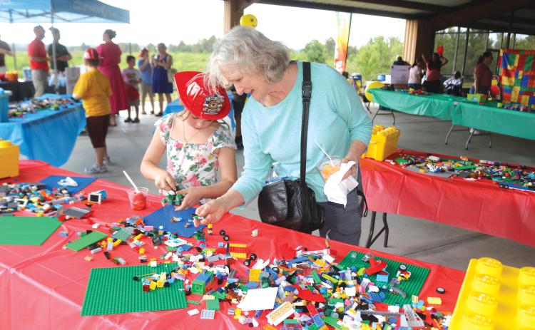 Denise Barth (right) works with 7-year-old Rowan Barth during Monday’s event. (TONY BRITT/Lake City Reporter)