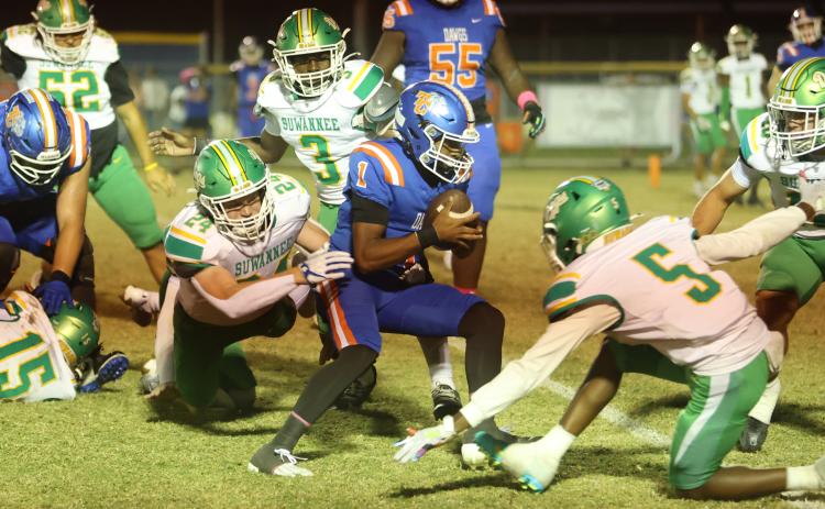 Suwannee defensive end Kyler Watson dives to try and tackle Taylor County quarterback Jabez Glanton as he runs through the Bulldogs’ defense on Friday. (PAUL BUCHANAN/Lake City Reporter)