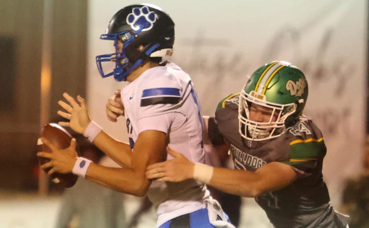Suwannee defensive end Kyler Watson pressures Godby quarterback Landon Dougherty on Sept. 12. (PAUL BUCHANAN/Lake City Reporter)