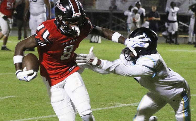 Fort White receiver Jayden Jackson stiff-arms a Zarephath Academy defender Friday night. (MORGAN MCMULLEN/Lake City Reporter)