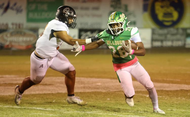 Suwannee running back Lou Jack Smith tries to escape a tackle from an Atlantic Coast defender last Friday. (PAUL BUCHANAN/Lake City Reporter)