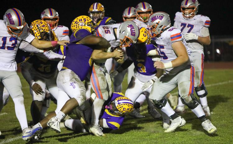 Bolles running back Xander Edwards carries Columbia defenders for extra yardage during his team’s 31-0 win on Friday. (BRENT KUYKENDALL/Lake City Reporter)