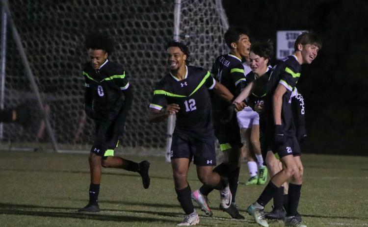 Columbia's Josiah Hopkins (12) celebrates with teammates after scoring a goal against Keystone Heights on Monday. (BRENT KUYKENDALL/Lake City Reporter)