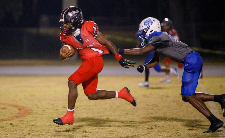 Fort White running back John'l Lawson breaks a tackle on his way to a touchdown against Wildwood during the FIT quarterfinals on Thursday. (BRENT KUYKENDALL/Lake City Reporter)