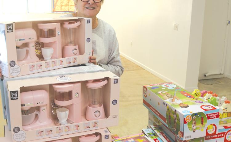 Meally Jenkins, Christmas Dream Machine founder and director, stands in front of a table filled with toys. The Christmas Dream Machine begins its 2025 operations today at 157 SE Duval Street in its 37th year of service to the community. (MORGAN MCMULLEN/Lake City Reporter)
