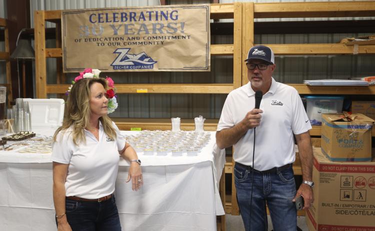 Bryan Zecher speaks at a celebration Tuesday of his company’s 30 years in business. Missy Zecher listens. (TONY BRITT/Lake City Reporter)