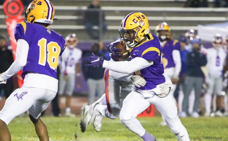 Columbia quarterback Xavier Collins tries to escape a Bolles’ tackler during Friday’s 31-0 loss. (BRENT KUYKENDALL/Lake City Reporter)