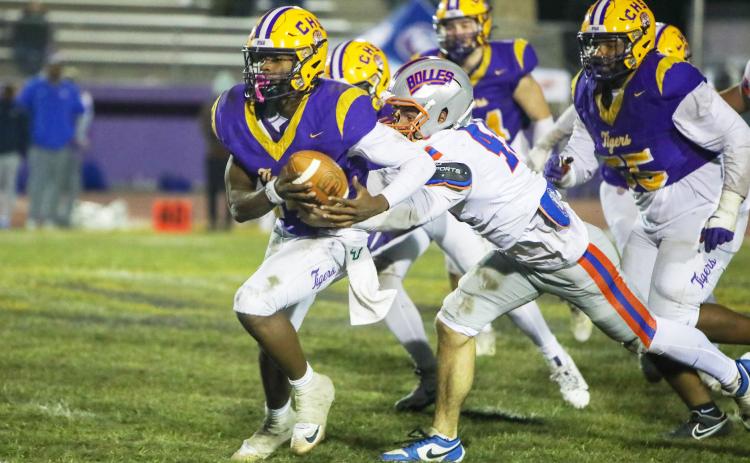 Columbia quarterback Xavier Collins tries to escape pressure from the Bolles defense on Oct. 31. (BRENT KUYKENDALL/Lake City Reporter)