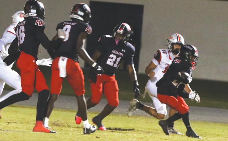 Fort White defensive back Mason Butler returns an interception against Baker County on Oct. 31. (MORGAN MCMULLEN/Lake City Reporter)