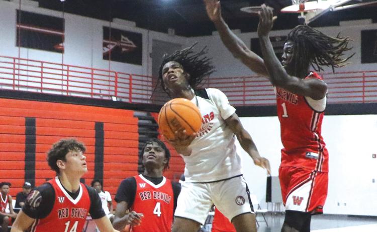 Fort White guard Tylan James goes airborne for a layup attempt against Williston during the Indians’ summer league opener in June. (FILE)
