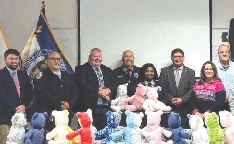 Representatives from the Columbia Correctional Institution and Lake City Police Department teamed up to give local inmates the materials necessary to build teddy bears to be used for kids in domestic violence situations. (COURTESY LAKE CITY POLICE DEPARTMENT)