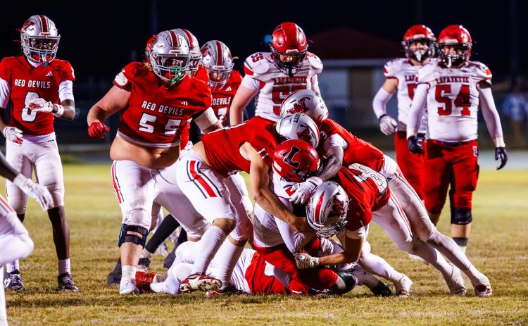 Lafayette quarterback Tywan Williamson gets buried by the Williston defense during Friday night’s Class Rural quarterfinal. (JACK HOWDESHELL/Lake City Reporter)