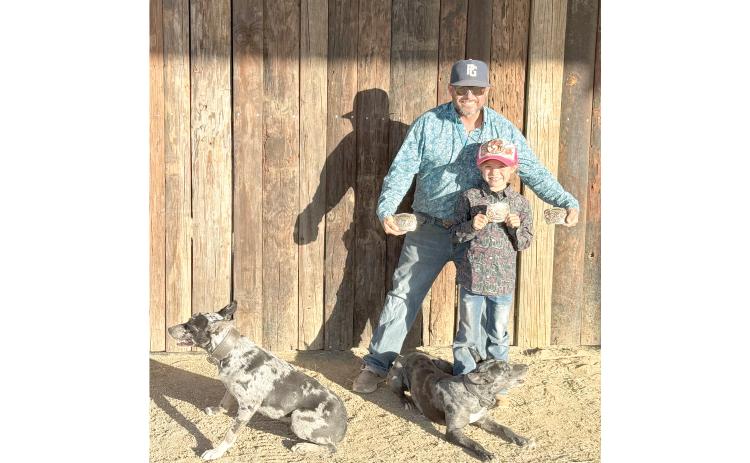 Jared and Harper Lee show off their world championship buckles won at the Ericsson Memorial trials in Texas. Harper Lee won the youth division with Rainbow, while Jared Lee won the futurity championship and open reserve with Kong. (COURTESY)