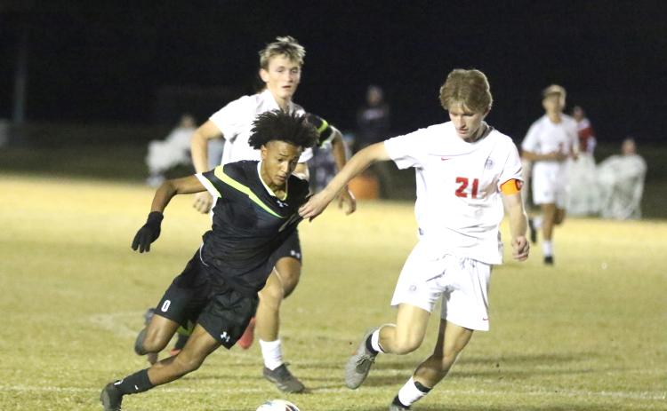 Columbia forward Colyn Weatherspoon is grabbed by Santa Fe defender Mason Kramer during Tuesday's 2-1 loss. (MORGAN MCMULLEN/Lake City Reporter)