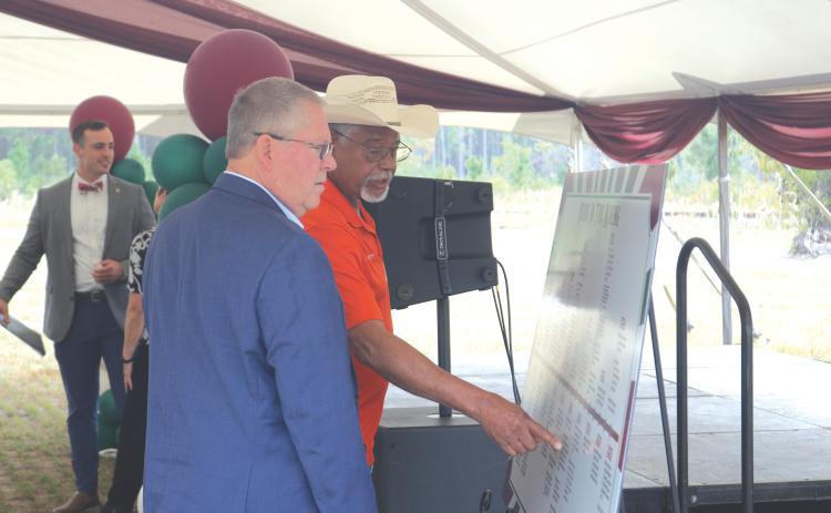 Former Columbia County Commissioner Ron Williams (right) points out a moment on the timeline of the North Florida Mega Industrial Park to Rep. Chuck Brannan during Thursday’s celebration. (TONY BRITT/Lake City Reporter)