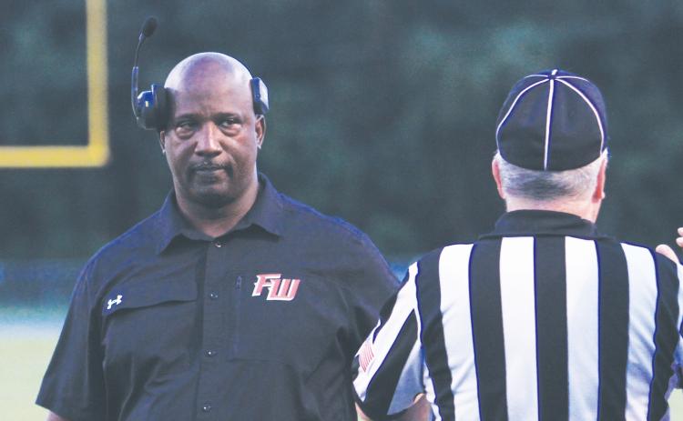 Fort White coach Demetric Jackson stares down a referee during a game last season. (FILE)