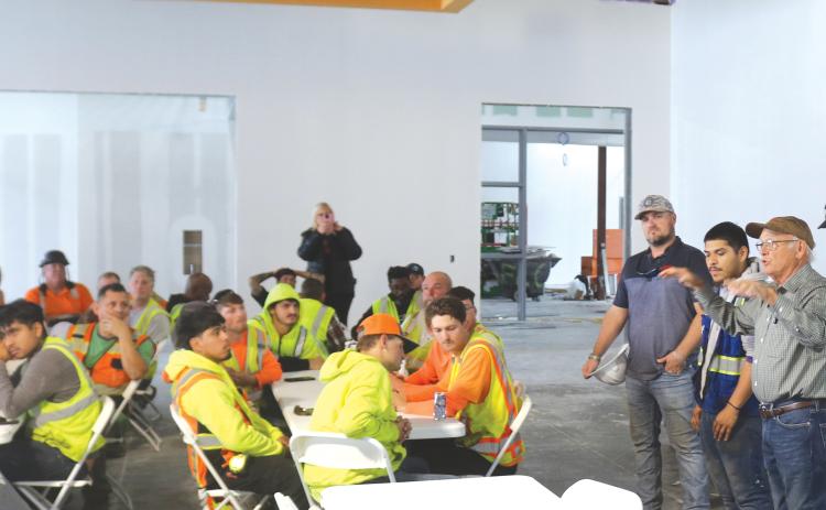 Keith Hudson (right), a Columbia County School Board member, offers construction workers a personal ‘Thank You’ for their work on the new Eastside Elementary during a topping-off ceremony and luncheon at the building on Tuesday morning. (TONY BRITT/Lake City Reporter)