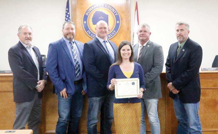 Suwannee County Economic Development Coordinator Charissa Setzer recently earned her Basic Economic Development Certification from the University of South Florida. Setzer was honored for the achievement at Tuesday’s Suwannee County Commission meeting by Economic Development Director Jimmy Norris (from left) and Commissioners Leo Mobley, Don Hale, Franklin White and Travis Land. (JAMIE WACHTER/Lake City Reporter)