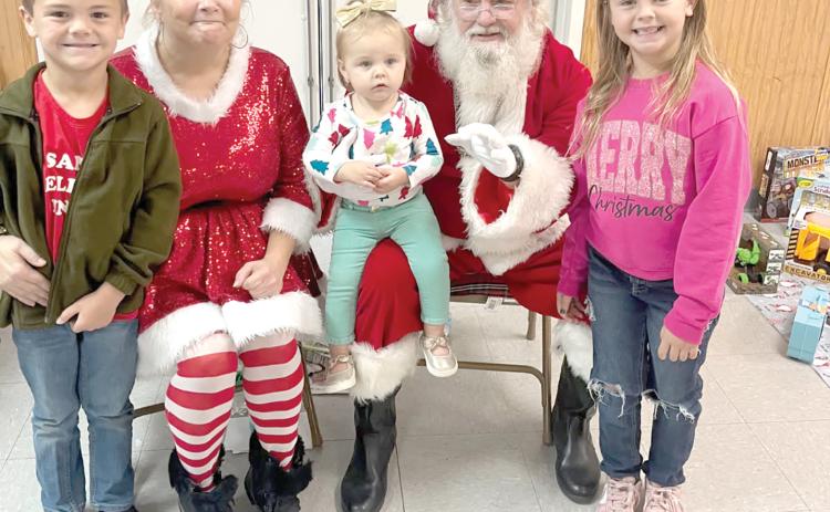 Santa and Mrs. Claus visit with children during the Breakfast with Santa event in Fort White on Saturday. (COURTESY)