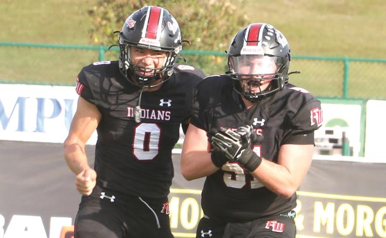 Fort White defensive lineman Ethan Shaw (51) celebrates after his fumble recovery alongside defensive back Ezekiel Powell (0) during the Indians’ 32-29 win over Port St. Joe in the FIT championship on Dec. 5. (MORGAN MCMULLEN/Lake City Reporter)