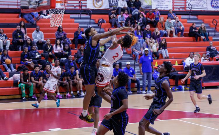 Fort White guard Desean Lally has his shot blocked by Newberry forward Brandon Kelly on Friday. (JACK HOWDESHELL/Lake City Reporter)