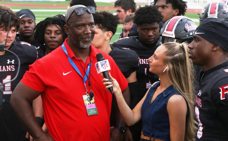 Fort White coach Demetric Jackson is interviewed by a reporter following the Indians’ 32-29 win over Port St. Joe in the FIT championship on Friday. (MORGAN MCMULLEN/Lake City Reporter)
