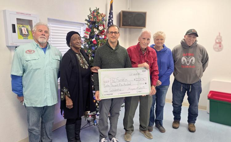 The Wellborn Community Association donated earlier this month toward a scholarship fund with the Foundation at Florida Gateway College to help students pursue Career and Technical Education degrees and certificates. Presenting the check to FGC Foundation Executive Director Lee Pinchouck were Sherm Stanley (from left), Fran Martin, Pinchouck, Bob Huffman, Pam Mikitta and Pedro Faria. (MONJA SLATER/Lake City Reporter)
