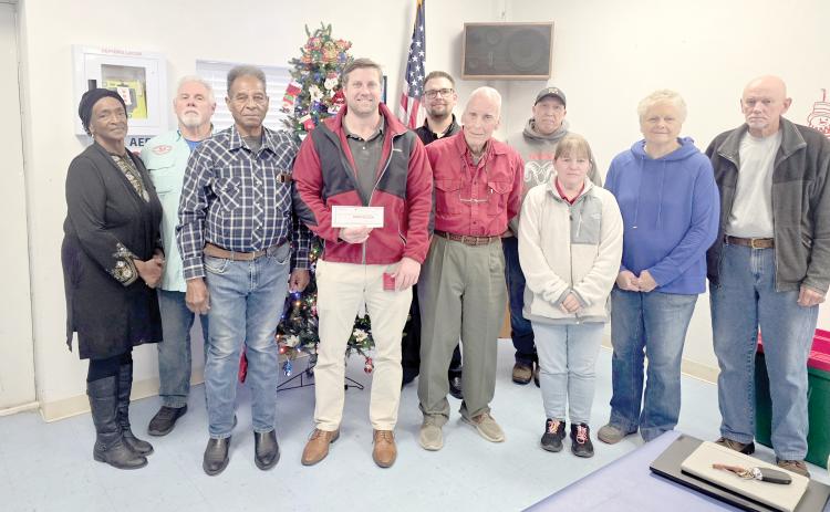 The Wellborn Community Association donated last week toward a scholarship fund at RIVEROAK Technical College to help students pursue Career and Technical Education degrees and certificates. Presenting the check to RTC Principal Clay Tomlinson were Fran Martin (from left), Sherm Stanley, Mayso Martin, Tomlinson, Austin Little, Bob Huffman, Pedro Faria, Lynn King, Pam Mikitta and Bill Muller. (MONJA SLATER/Lake City Reporter)