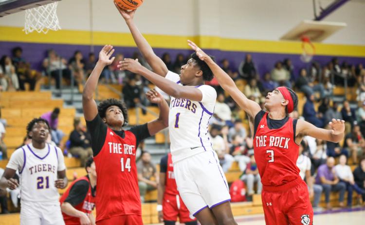 Columbia guard Shaheed White drives between The Rock defense for a layup on Tuesday. (BRENT KUYKENDALL/Lake City Reporter)