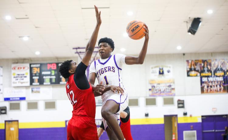 Columbia guard Shaheed White goes up for a layup against The Rock on Jan. 6. (BRENT KUYKENDALL/Lake City Reporter)