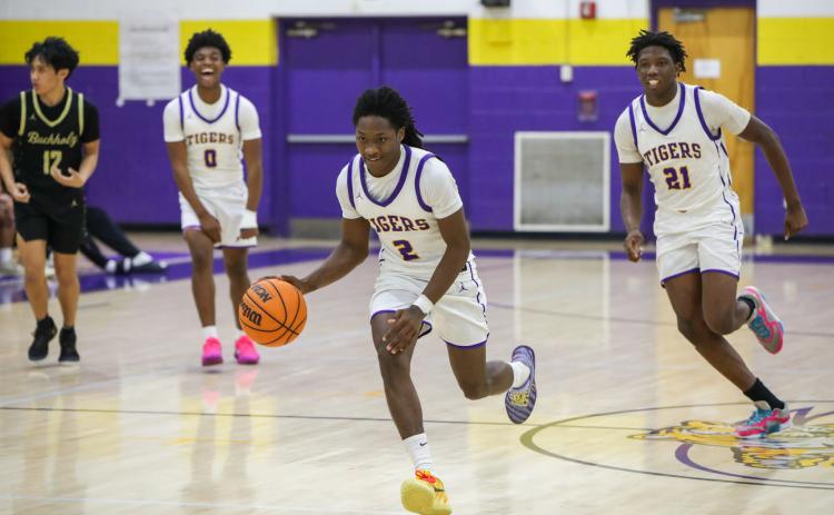 Columbia guard Kadrian Willson dribbles on a fast break for a game-sealing dunk against Buchholz on Tuesday. (BRENT KUYKENDALL/Lake City Reporter)