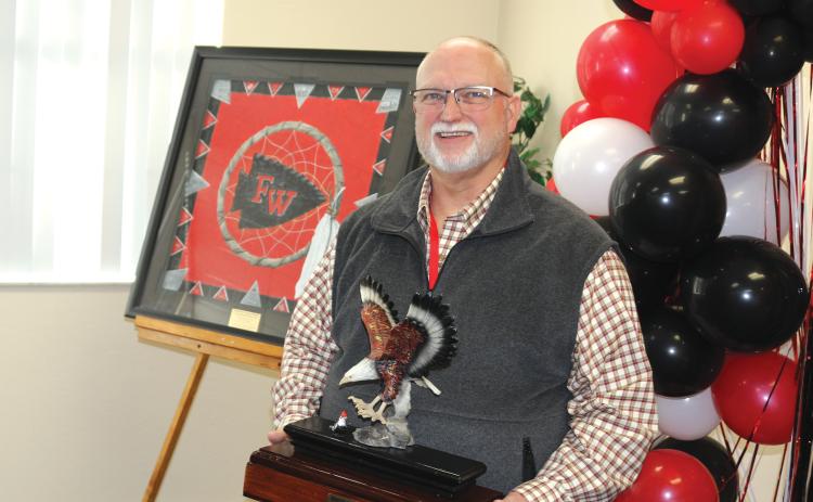 Former Fort White High School principal Keith Hatcher holds a ceremonial eagle plaque at his retirement party. Hatcher served as the high school’s first principal. (TONY BRITT/Lake City Reporter)