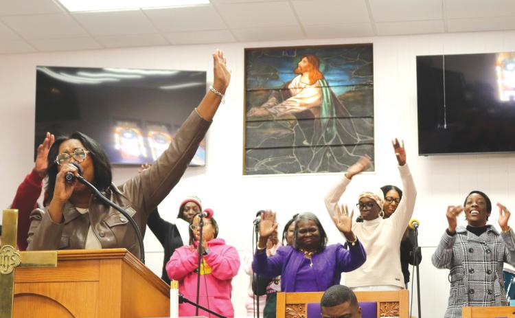 LaJoyce Ingraham (left) leads a song during the MLK Church service on Monday afternoon at New Mt. Pisgah AME Church. The service took place immediately following the MLK parade. (TONY BRITT/Lake City Reporter)