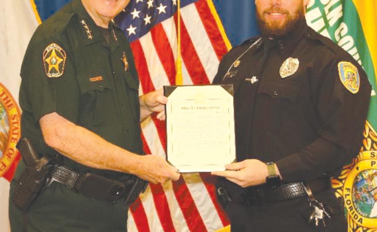 Polk County Sheriff Grady Judd (left) presents a Sheriff’s Commendation award to Lake City Police Department Detective Richard Poteat for his efforts in Operation Child Protector VII, which resulted in the arrest of a Montana man. (COURTESY LAKE CITY POLICE DEPARTMENT)