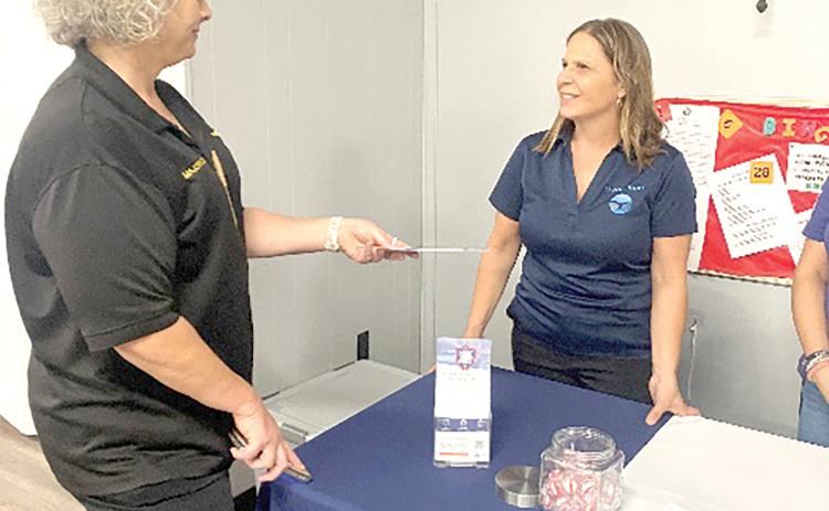 Barbara Etter, community services coordinator with Living Hope, speaks to Columbia County Chief Deputy Katina Dicks at a local event. (COURTESY)