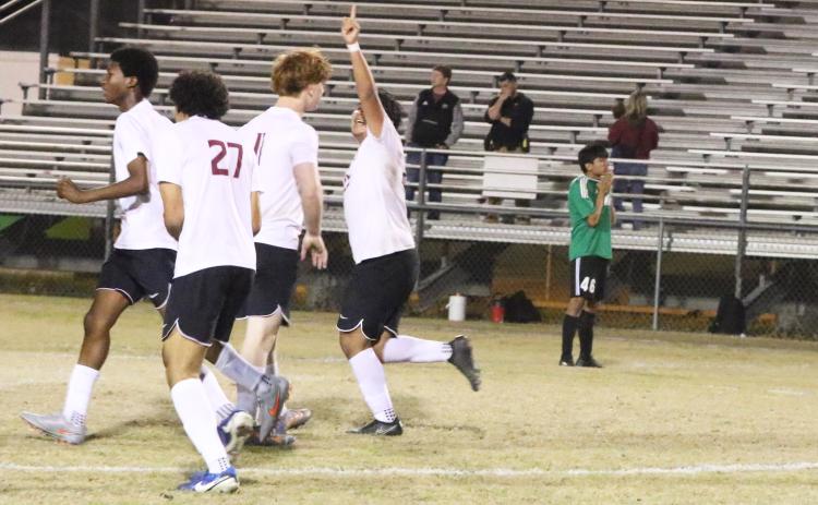 Suwannee striker Hector Velasquez (46) stands disappointed as Florida High’s Manuel Hernandez celebrates teammate Keenen Jeune’s game-winning goal in double overtime of Friday’s District 2-3A semifinal. (MORGAN MCMULLEN/Lake City Reporter)
