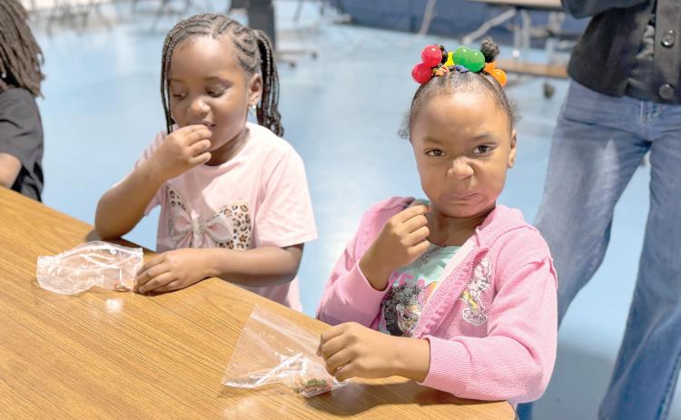 Minnie J. Niblack Elementary students A’mari and Rylee try edamame for the first time during a taste test at the end of the Serving Up MyPlate lesson. (COURTESY UF/IFAS EXTENSION COLUMBIA COUNTY)