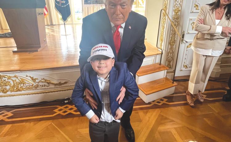 Rep. Chuck Brannan’s son, Rafe, is held by President Donald Trump during Friday’s ceremony. (COURTESY)
