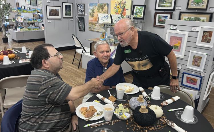 Gateway Art Gallery artist and Navy veteran Benjamin Ragland (right) greets military veterans Richard Raposo and Russell Fulmer from the Robert H. Jenkins Jr. Domiciliary at a previous presentation at the Gallery. (COURTESY)