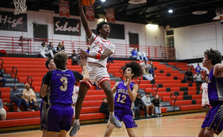 Fort White guard Desean Lally throws a pass during Tuesday's District 6-R quarterfinal against Bell. (BRENT KUYKENDALL/Lake City Reporter)