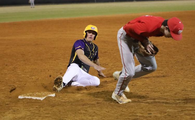 Columbia pitcher Tison McCray slides safely into third base against Santa Fe on Monday. (BRENT KUYKENDALL/Lake City Reporter)