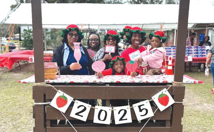 A family poses for a pic at the photo station during last year’s Live Oak Strawberry Festival. This year’s festival begins at 10 a.m. Saturday at the Suwannee County Fairgrounds in Live Oak. (COURTESY)