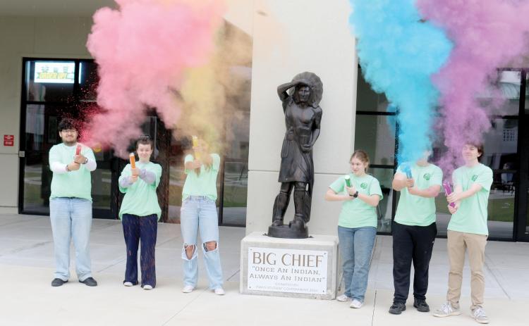 Fort White High School National Honor Society officers Juan Bustamante (from left), Jada Knight, Leah Gianos, Sarah Heeke, Jack Schroader and Cody Maggard shoot off containers of color as they prepare for the school’s annual color fun run which will take place next Saturday. (TONY BRITT/Lake City Reporter)