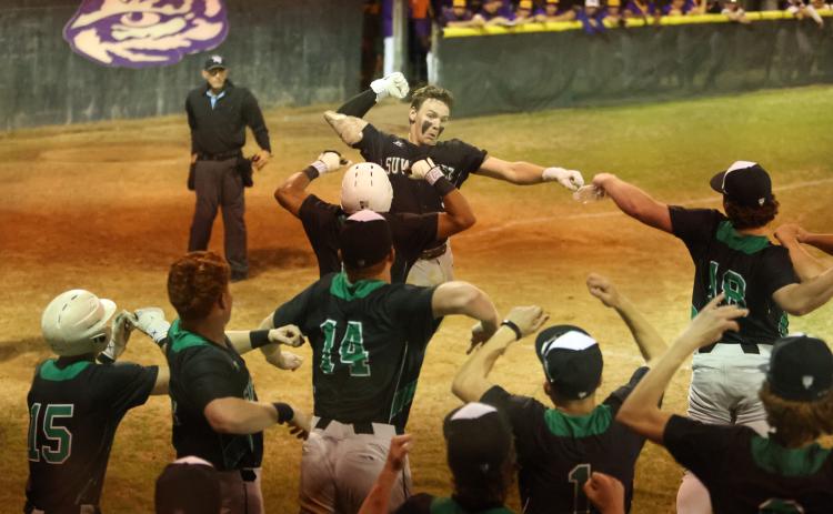 Suwannee catcher Jace Moran celebrates with teammates after hitting a two-run home run against Columbia on Wednesday. (PAUL BUCHANAN/Lake City Reporter)