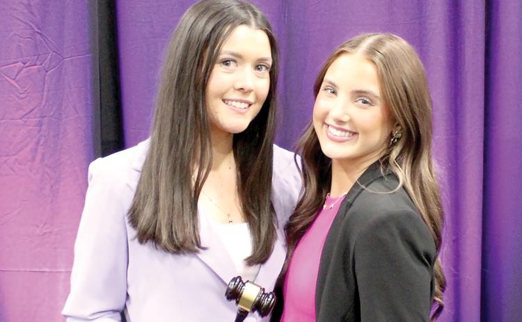 Lyla Folsom (right), Columbia High Student Government Association’s represenative, receives the gavel from Gainesville High’s Macy Gleason as CHS is now the Florida Association of Student Councils District 2 president. Gleason and GHS held the position the past year. (COURTESY)